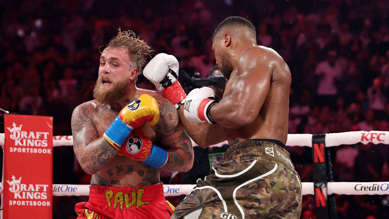 MIAMI, FLORIDA - DECEMBER 19: (L-R) Jake Paul fights Anthony Joshua in their heavyweight bout during Jake Paul v Anthony Joshua at Kaseya Center on December 19, 2025 in Miami, Florida.