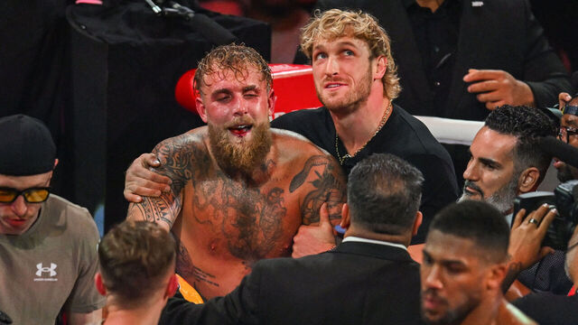 YouTuber Logan Paul (R) holds his brother, US boxer and influencer Jake Paul, after he lost to British boxer Anthony Joshua (off frame) in a nontitle heavyweight bout at the Kaseya Center in Miami, Florida, on December 19, 2025.