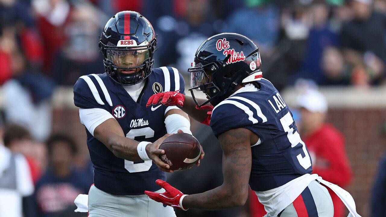 OXFORD, MISSISSIPPI - DECEMBER 20: Trinidad Chambliss #6 of the Ole Miss Rebels hands the ball to Kewan Lacy #5 during the first quarter of the 2025 College Football Playoff First Round Game against the Tulane Green Wave at Vaught-Hemingway Stadium on December 20, 2025 in Oxford, Mississippi.