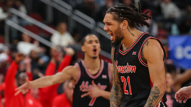 NEWARK, NEW JERSEY - DECEMBER 20: Emanuel Sharp #21 of the Houston Cougars reacts after a basket against the Arkansas Razorbacks during the second half of the Never Forget Tribute Classic at Prudential Center on December 20, 2025 in Newark, New Jersey.