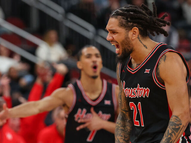 NEWARK, NEW JERSEY - DECEMBER 20: Emanuel Sharp #21 of the Houston Cougars reacts after a basket against the Arkansas Razorbacks during the second half of the Never Forget Tribute Classic at Prudential Center on December 20, 2025 in Newark, New Jersey.