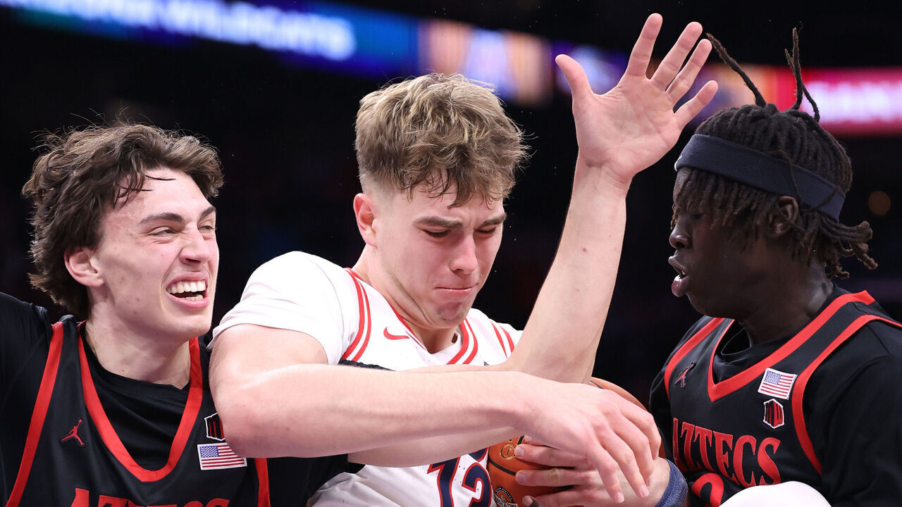 PHOENIX, ARIZONA - DECEMBER 20: Motiejus Krivas #13 of the Arizona Wildcats controls a rebound against Miles Heide #40 (L) and Magoon Gwath #0 of the San Diego State Aztecs during the second half at Mortgage Matchup Center on December 20, 2025 in Phoenix, Arizona.