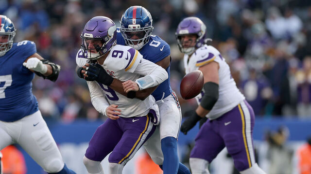 EAST RUTHERFORD, NEW JERSEY - DECEMBER 21: J.J. McCarthy #9 of the Minnesota Vikings fumbles the ball while being hit by Brian Burns #0 of the New York Giants in the second quarter of a game at MetLife Stadium on December 21, 2025 in East Rutherford, New Jersey.