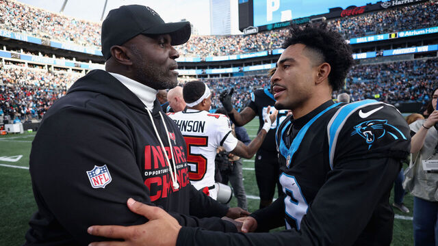 CHARLOTTE, NORTH CAROLINA - DECEMBER 21: Head coach Todd Bowles of the Tampa Bay Buccaneers and Bryce Young #9 of the Carolina Panthers hug after Carolina's 23-20 victory at Bank of America Stadium on December 21, 2025 in Charlotte, North Carolina.