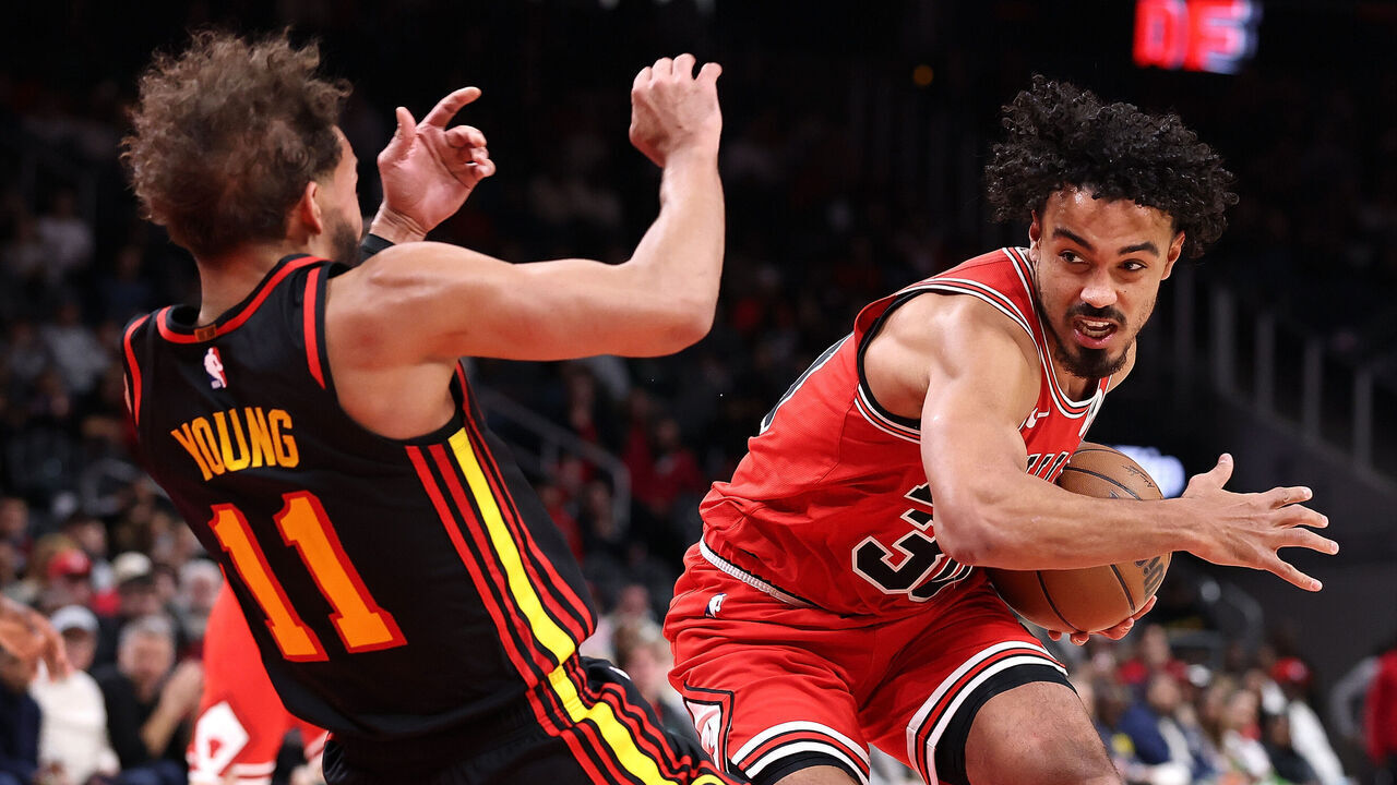 ATLANTA, GEORGIA - DECEMBER 21: Tre Jones #30 of the Chicago Bulls draws a foul as he drives into Trae Young #11 of the Atlanta Hawks during the fourth quarter at State Farm Arena on December 21, 2025 in Atlanta, Georgia.