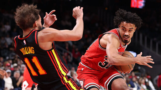 ATLANTA, GEORGIA - DECEMBER 21: Tre Jones #30 of the Chicago Bulls draws a foul as he drives into Trae Young #11 of the Atlanta Hawks during the fourth quarter at State Farm Arena on December 21, 2025 in Atlanta, Georgia.
