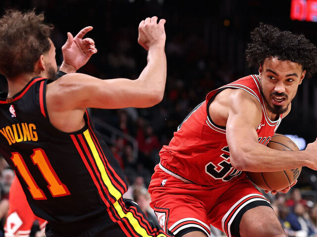 ATLANTA, GEORGIA - DECEMBER 21: Tre Jones #30 of the Chicago Bulls draws a foul as he drives into Trae Young #11 of the Atlanta Hawks during the fourth quarter at State Farm Arena on December 21, 2025 in Atlanta, Georgia.