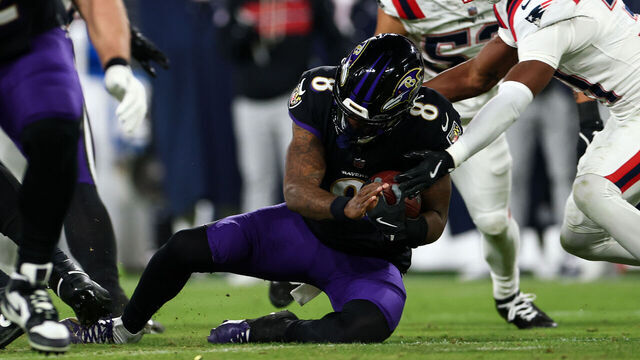 BALTIMORE, MARYLAND - DECEMBER 21: Lamar Jackson #8 of the Baltimore Ravens slides with the ball during the second quarter against the New England Patriots at M&T Bank Stadium on December 21, 2025 in Baltimore, Maryland.