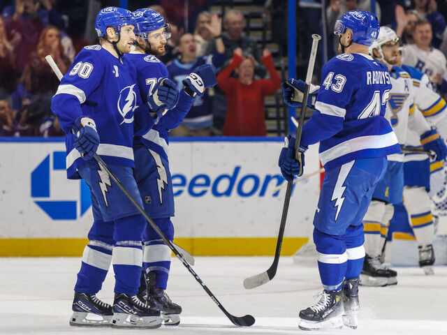 TAMPA, FL - DECEMBER 22: Anthony Cirelli #71 of the Tampa Bay Lightning celebrates a goal with teammates J.J. Moser #90 and Darren Raddysh #43 against the St. Louis Blues at Benchmark International Arena on December 22, 2025 in Tampa, Florida.