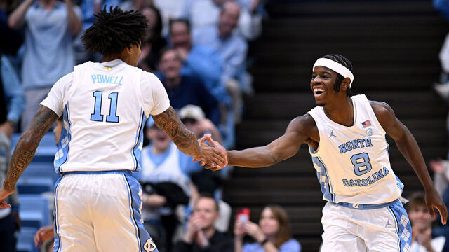 CHAPEL HILL, NORTH CAROLINA - DECEMBER 22: Jonathan Powell #11 and Caleb Wilson #8 of the North Carolina Tar Heels react during the first half of the game against the East Carolina Pirates at Dean E. Smith Center on December 22, 2025 in Chapel Hill, North Carolina.