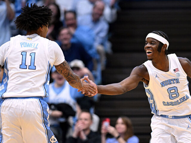 CHAPEL HILL, NORTH CAROLINA - DECEMBER 22: Jonathan Powell #11 and Caleb Wilson #8 of the North Carolina Tar Heels react during the first half of the game against the East Carolina Pirates at Dean E. Smith Center on December 22, 2025 in Chapel Hill, North Carolina.