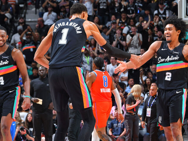 SAN ANTONIO, TX - DECEMBER 23: Victor Wembanyama #1 high fives Dylan Harper #2 of the San Antonio Spurs during the game against the Oklahoma City Thunder on December 23, 2025 at the Frost Bank Center in San Antonio, Texas. Mandatory Copyright Notice: Copyright 2025 NBAE (Photos by Michael Gonzales/NBAE via Getty Images)