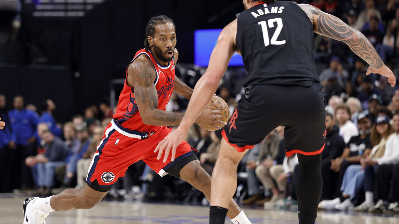 INGLEWOOD, CALIFORNIA - DECEMBER 23: Kawhi Leonard #2 of the LA Clippers controls the ball against Steven Adams #12 of the Houston Rockets in the first half at Intuit Dome on December 23, 2025 in Inglewood, California.