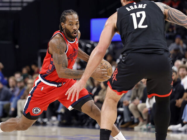 INGLEWOOD, CALIFORNIA - DECEMBER 23: Kawhi Leonard #2 of the LA Clippers controls the ball against Steven Adams #12 of the Houston Rockets in the first half at Intuit Dome on December 23, 2025 in Inglewood, California.