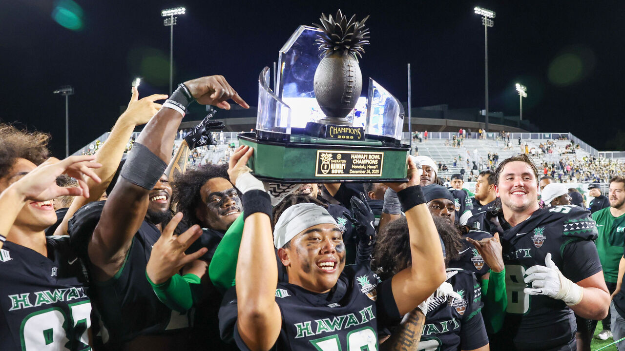 HONOLULU, Hawai'i - DECEMBER 24: Micah Alejado #12 of the Hawai'i Rainbow Warriors holds up the Hawai'i Bowl Championship trophy after winning the Sheraton Hawai'i Bowl over the California Golden Bears at the Clarence T.C. Ching Athletics Complex on December 24, 2025 in Honolulu, Hawai'i.