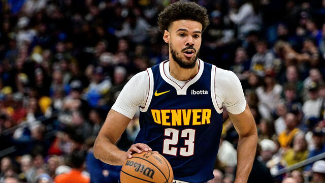 DENVER, COLORADO - DECEMBER 22: Cameron Johnson #23 of the Denver Nuggets dribbles in the first half of a game against the Utah Jazz at Ball Arena on December 22, 2025 in Denver, Colorado.
