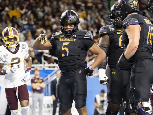 DETROIT, MI - DECEMBER 26: Northwestern Wildcats running back Caleb Komolafe (5) celebrates after running the ball for a touchdown during the GameAbove Sports Bowl between the Central Michigan Chippewas and the Northwestern Wildcats on December 26, 2025, at Ford Field in Detroit, Michigan.