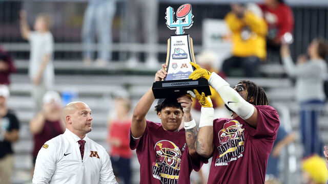 PHOENIX, ARIZONA - DECEMBER 26: Jalen Smith #8 (C) and Anthony Smith #0 of the Minnesota Golden Gophers hold the championship trophy alongside head coach P. J. Fleck after defeating the New Mexico Lobos 20-17 in overtime of the 2025 Rate Bowl at Chase Field on December 26, 2025 in Phoenix, Arizona.