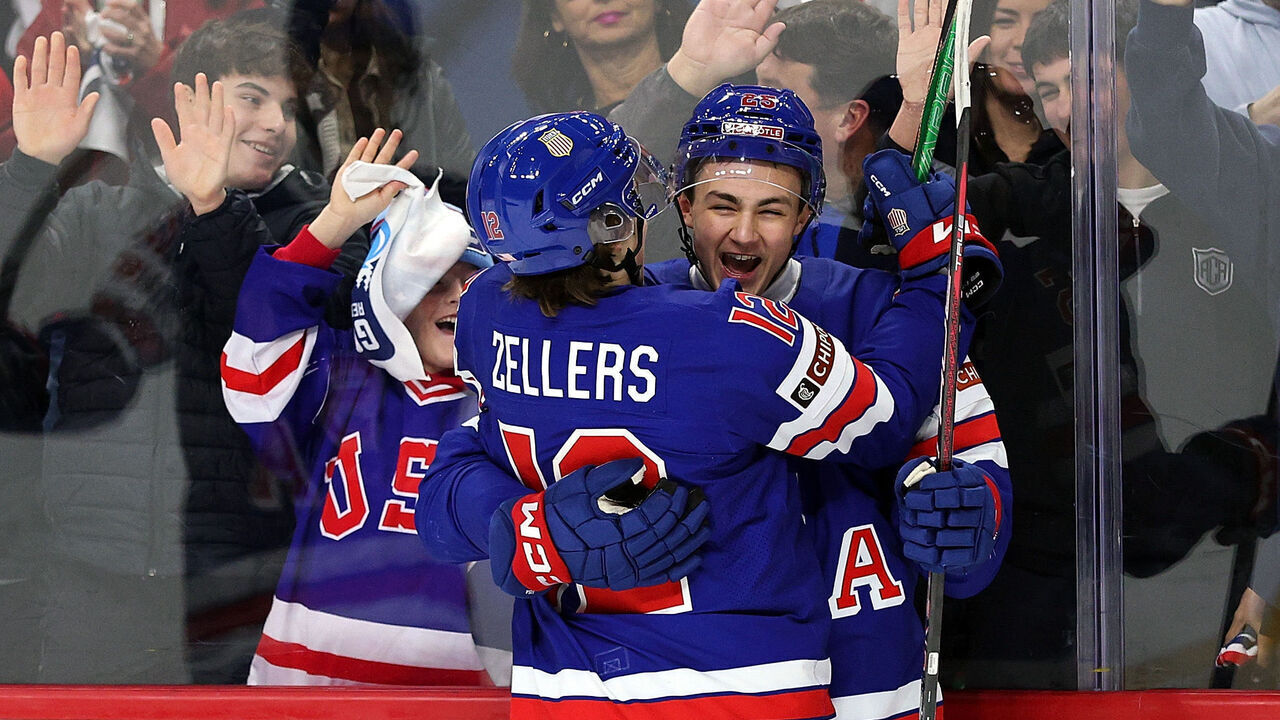 ST PAUL, MINNESOTA - DECEMBER 26: Chase Reid #25 of the United States (R) celebrates his goal against Germany with teammate Will Zellers #12 in the first period of a group stage game at Grand Casino Arena on December 26, 2025 in St Paul, Minnesota.