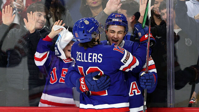 ST PAUL, MINNESOTA - DECEMBER 26: Chase Reid #25 of the United States (R) celebrates his goal against Germany with teammate Will Zellers #12 in the first period of a group stage game at Grand Casino Arena on December 26, 2025 in St Paul, Minnesota.