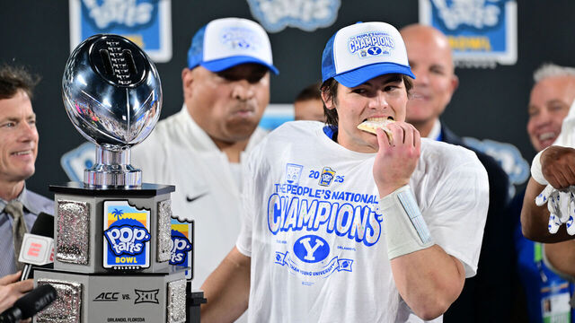 ORLANDO, FLORIDA - DECEMBER 27: Bear Bachmeier #47 of the BYU Cougars bites into a pop-tart after winning the Most Valuable Player award following the 2025 Pop-Tarts Bowl against the Georgia Tech Yellow Jackets at Camping World Stadium on December 27, 2025 in Orlando, Florida. The BYU Cougars defeated the Georgia Tech Yellow Jackets 25-21.