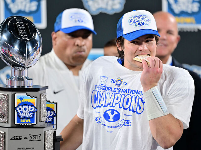 ORLANDO, FLORIDA - DECEMBER 27: Bear Bachmeier #47 of the BYU Cougars bites into a pop-tart after winning the Most Valuable Player award following the 2025 Pop-Tarts Bowl against the Georgia Tech Yellow Jackets at Camping World Stadium on December 27, 2025 in Orlando, Florida. The BYU Cougars defeated the Georgia Tech Yellow Jackets 25-21.