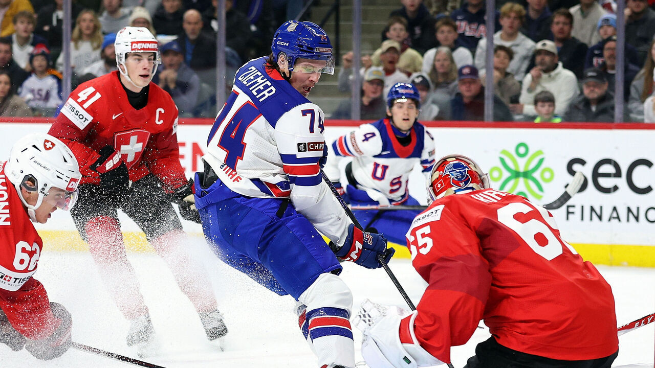 ST PAUL, MINNESOTA - DECEMBER 27: Christian Kirsch #65 of Switzerland makes a save against Brodie Ziemer #74 of the United States in the first period of a Group A stage game at Grand Casino Arena on December 27, 2025 in St Paul, Minnesota.