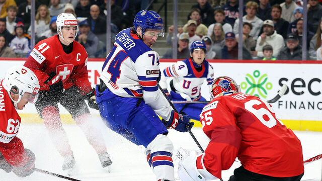ST PAUL, MINNESOTA - DECEMBER 27: Christian Kirsch #65 of Switzerland makes a save against Brodie Ziemer #74 of the United States in the first period of a Group A stage game at Grand Casino Arena on December 27, 2025 in St Paul, Minnesota.
