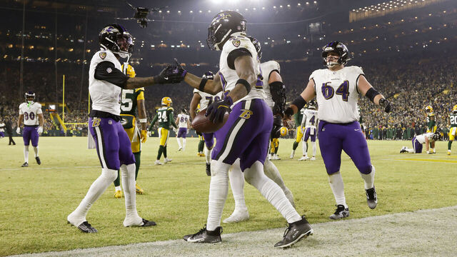 GREEN BAY, WISCONSIN - DECEMBER 27: Derrick Henry #22 of the Baltimore Ravens celebrates with teammates after scoring a touchdown in the second quarter against the Green Bay Packers at Lambeau Field on December 27, 2025 in Green Bay, Wisconsin.