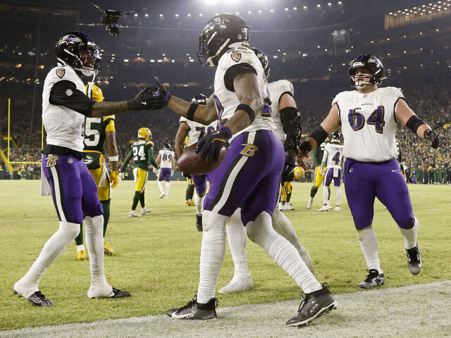 GREEN BAY, WISCONSIN - DECEMBER 27: Derrick Henry #22 of the Baltimore Ravens celebrates with teammates after scoring a touchdown in the second quarter against the Green Bay Packers at Lambeau Field on December 27, 2025 in Green Bay, Wisconsin.