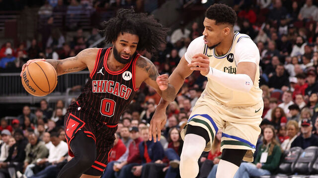 CHICAGO, ILLINOIS - DECEMBER 27: Coby White #0 of the Chicago Bulls dribbles past Giannis Antetokounmpo #34 of the Milwaukee Bucks during the second half at the United Center on December 27, 2025 in Chicago, Illinois.