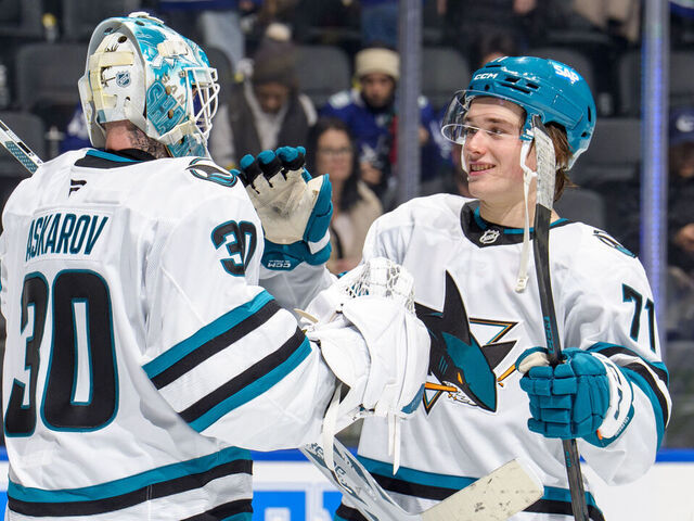 VANCOUVER, CANADA - DECEMBER 27: Yaroslav Askarov #30 celebrates with Macklin Celebrini #71 of the San Jose Sharks after their win against the Vancouver Canucks at Rogers Arena on December 27, 2025 in Vancouver, British Columbia, Canada. Sharks won 6-3.