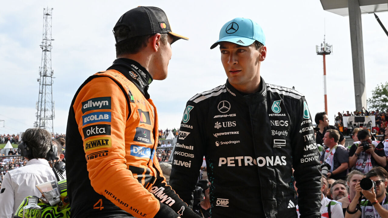 BUDAPEST, HUNGARY - AUGUST 03: Race winner Lando Norris of Great Britain and McLaren and Third placed George Russell of Great Britain and Mercedes AMG Petronas F1 Team talk in parc ferme during the F1 Grand Prix of Hungary at Hungaroring on August 03, 2025 in Budapest, Hungary.