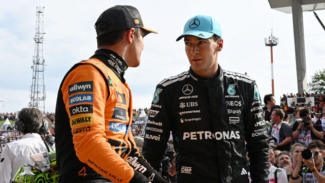BUDAPEST, HUNGARY - AUGUST 03: Race winner Lando Norris of Great Britain and McLaren and Third placed George Russell of Great Britain and Mercedes AMG Petronas F1 Team talk in parc ferme during the F1 Grand Prix of Hungary at Hungaroring on August 03, 2025 in Budapest, Hungary.