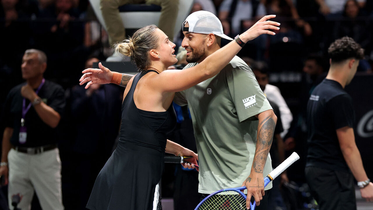 Belarus' Aryna Sabalenka and Australia's Nick Kyrgios embrace at the net after the Battle of the Sexes tennis match at the Coca-Cola Arena in Dubai on December 28, 2025.