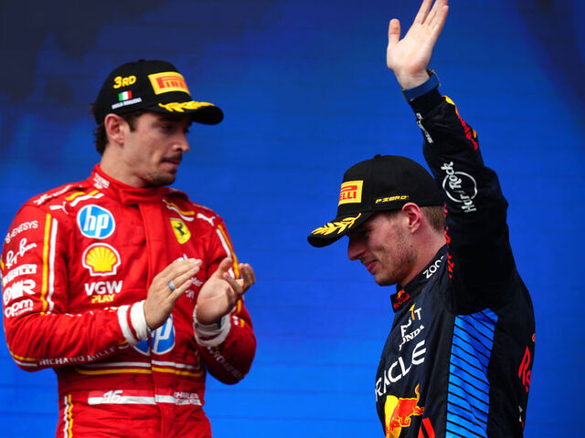 Red Bull Racing's Max Verstappen after winning the Emilia Romagna Grand Prix, as Ferrari's Charles Leclerc applauds. Picture date: Sunday May 19, 2024.