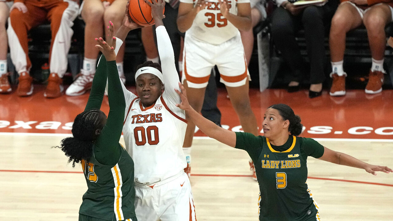 AUSTIN, TEXAS - DECEMBER 28: Kyla Oldacre #00 of the Texas Longhorns looks to pass the ball as she is defended by Eryn McKinzie #3 and Bethany Graves #13 of the Southeastern Louisiana Lady Lions during the second half at Moody Center on December 28, 2025 in Austin, Texas.