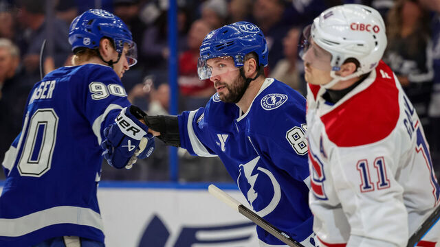 TAMPA, FLORIDA - DECEMBER 28: Nikita Kucherov #86 of the Tampa Bay Lightning celebrates his goal with teammate J.J. Moser #90 as Brendan Gallagher #11 of the Montréal Canadiens reacts during the second period at the Benchmark International Arena on December 28, 2025 in Tampa, Florida.