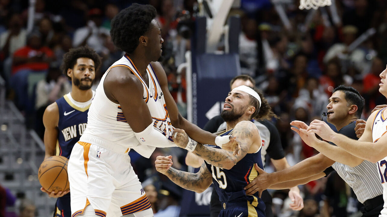 NEW ORLEANS, LOUISIANA - DECEMBER 27: Jose Alvarado #15 of the New Orleans Pelicans gets into a scrum with Mark Williams #15 of the Phoenix Suns during the second half of a game at Smoothie King Center on December 27, 2025 in New Orleans, Louisiana.