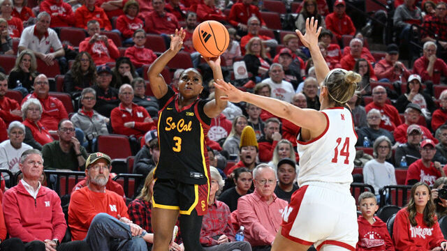 LINCOLN, NEBRASKA - DECEMBER 29: Londynn Jones #3 of the Southern California Trojans scores on a three-point shot over Callin Hake #14 of the Nebraska Cornhuskers during the second half at Pinnacle Bank Arena on December 29, 2025 in Lincoln, Nebraska.