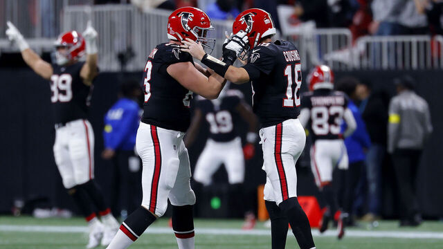 ATLANTA, GEORGIA - DECEMBER 29: Kirk Cousins #18 of the Atlanta Falcons celebrates a touchdown by Bijan Robinson #7 (not pictured) with Chris Lindstrom #63 against the Los Angeles Rams during the second quarter at Mercedes-Benz Stadium on December 29, 2025 in Atlanta, Georgia.