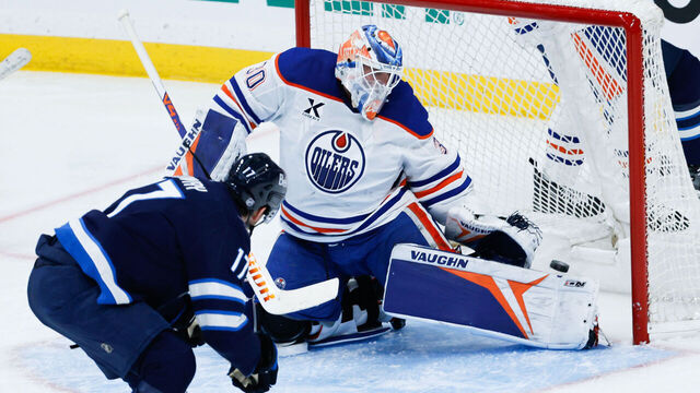 WINNIPEG, MB - DECEMBER 29: Winnipeg Jets forward Adam Lowry (17) scores on Edmonton Oilers goalie Calvin Pickard (30) during the third period of the game between the Winnipeg Jets and the Edmonton Oilers on December 29, 2025 at the Canada Life Centre Winnipeg, Manitoba.