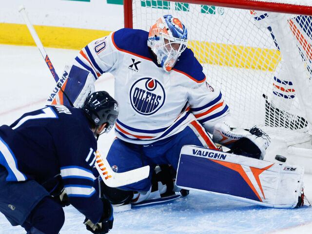 WINNIPEG, MB - DECEMBER 29: Winnipeg Jets forward Adam Lowry (17) scores on Edmonton Oilers goalie Calvin Pickard (30) during the third period of the game between the Winnipeg Jets and the Edmonton Oilers on December 29, 2025 at the Canada Life Centre Winnipeg, Manitoba.