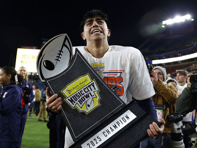NASHVILLE, TN - DECEMBER 30: Illinois Fighting Illini kicker David Olano (24) walks around the field holding the championship trophy following the Liberty Mutual Music City Bowl between the Tennessee Volunteers and Illinois Fighting Illini, December 30, 2025, at Nissan Stadium in Nashville, Tennessee.