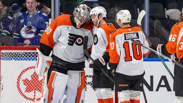 VANCOUVER, CANADA - DECEMBER 30: Dan Vladar #80 celebrates with Cam York #8 of the Philadelphia Flyers after their win against the Vancouver Canucks at Rogers Arena on December 30, 2025 in Vancouver, British Columbia, Canada. Flyers won 6-3.