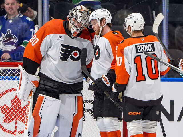 VANCOUVER, CANADA - DECEMBER 30: Dan Vladar #80 celebrates with Cam York #8 of the Philadelphia Flyers after their win against the Vancouver Canucks at Rogers Arena on December 30, 2025 in Vancouver, British Columbia, Canada. Flyers won 6-3.