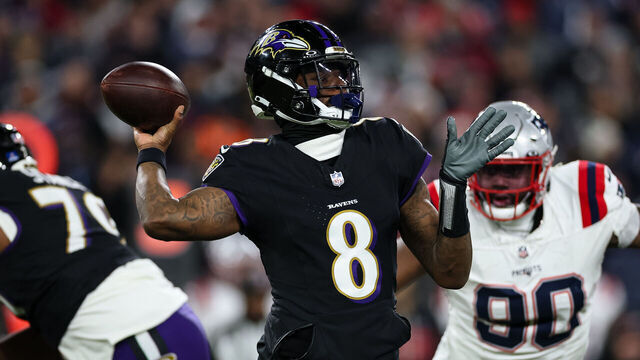 BALTIMORE, MD - DECEMBER 21: Lamar Jackson #8 of the Baltimore Ravens attempts a pass against the New England Patriots during the first half at M&T Bank Stadium on December 21, 2025 in Baltimore, Maryland.