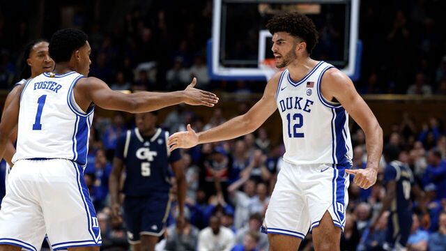 DURHAM, NORTH CAROLINA - DECEMBER 31: Caleb Foster #1 high-fives Cameron Boozer #12 of the Duke Blue Devils in the second half against the Georgia Tech Yellow Jackets at Cameron Indoor Stadium on December 31, 2025 in Durham, North Carolina.