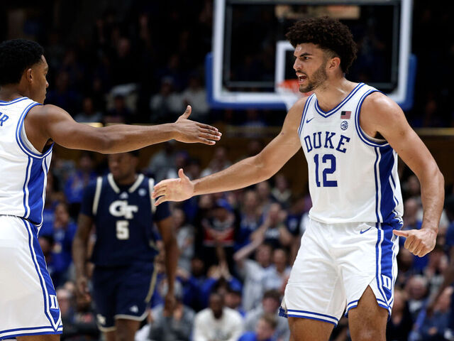 DURHAM, NORTH CAROLINA - DECEMBER 31: Caleb Foster #1 high-fives Cameron Boozer #12 of the Duke Blue Devils in the second half against the Georgia Tech Yellow Jackets at Cameron Indoor Stadium on December 31, 2025 in Durham, North Carolina.