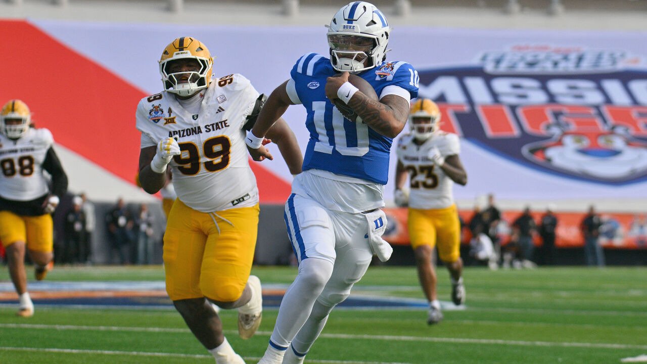EL PASO, TEXAS - DECEMBER 31: Quarterback Darian Mensah #10 of the Duke Blue Devils scrambles for yardage against defensive lineman C.J. Fite #99 of the Arizona State Sun Devils during the second half of the Tony The Tiger Sun Bowl game at Sun Bowl Stadium on December 31, 2025 in El Paso, Texas. The Blue Devils defeated the Sun Devils 42-39.